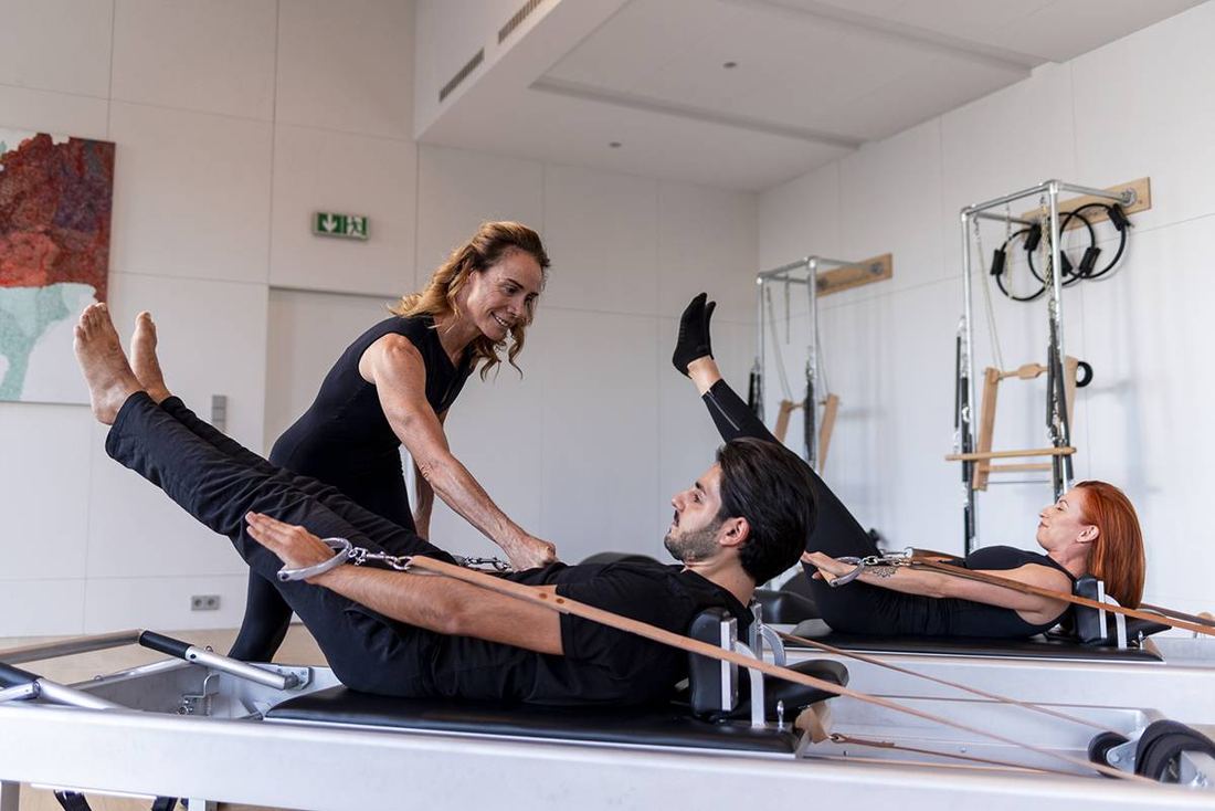 Duet Pilates session with hands-on instruction